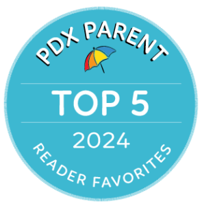 A light blue circular badge with a multicolor umbrella recognizes Pediatric Associates of the Northwest as a PDX Parent Reader Favorites nominee for 2024.